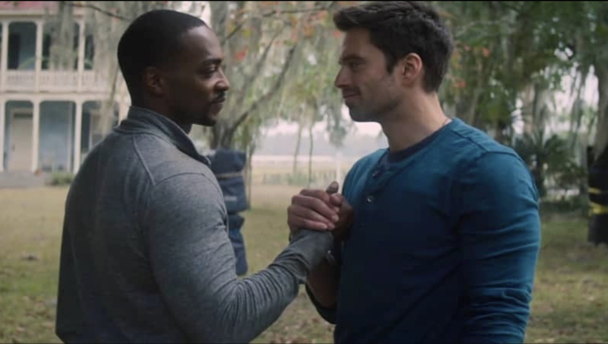 Sam and Bucky holding hands.